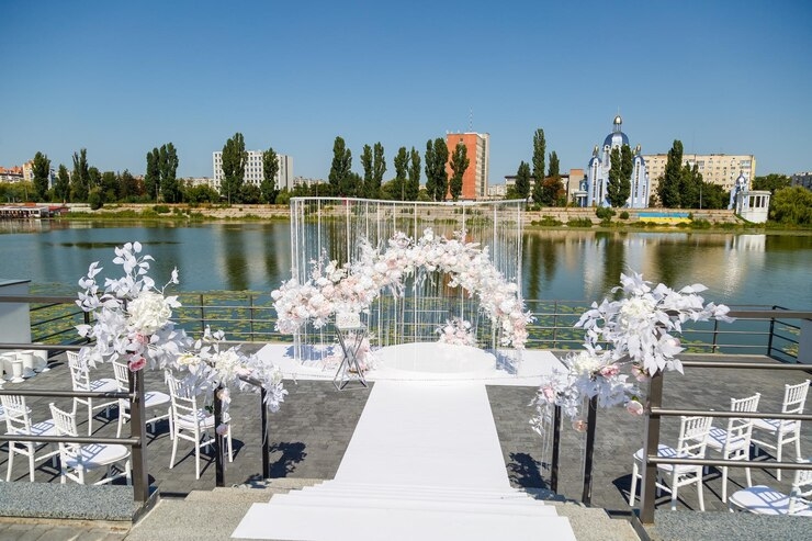 A destination wedding ceremony set up in front of a lake.