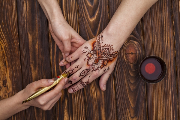 A bride's hands adorned with henna Mehndi Designs.	